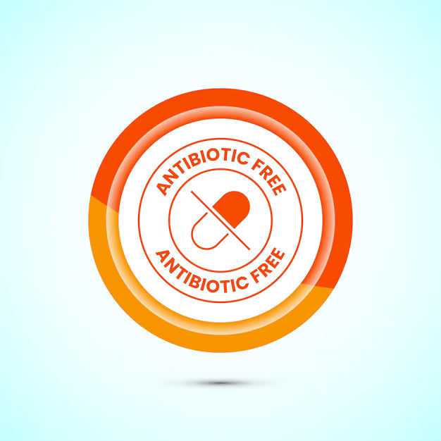 This is an image with a circular symbol and a drug capsule in the centre with a strike through it.  The caption above and below the capsule says Antibiotic Free